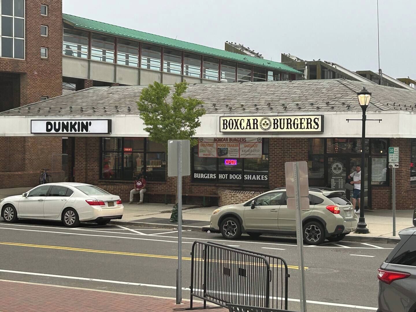 A street view with a Dunkin' and a Boxcar Burgers storefront.