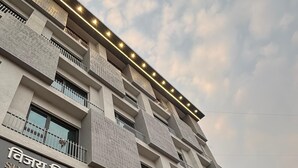 A multi-story hotel with a modern facade, balconies, and a sign indicating it has been established since 1942. - HOTEL VIJAY VILAS (Jalna)