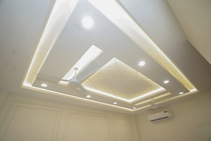A ceiling with recessed lighting and a central fan.