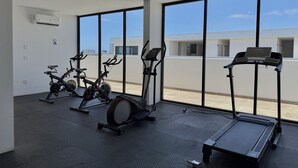 A gym with stationary bikes, an elliptical, and a treadmill. - Depa in Cerritos near the Beach with Great Amenities By GPS (Mazatlán)