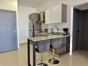 Fridge, microwave, stovetop, coffee/tea maker