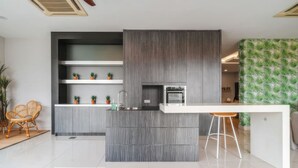 A modern kitchen with a central island, built-in appliances, and a bar area. - The Embassy Row 206 Apartments (Kuala Lumpur)