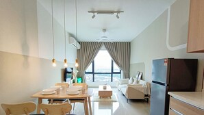 A modern kitchen with a dining area, a refrigerator, and a view of the city. - Aradia Residence Lake City KL North (Kuala Lumpur)