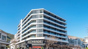 A multi-story hotel with a modern design, featuring balconies and a prominent sign for 'The SAGE'. - The Sage Aparthotel by Totalstay (CAPE TOWN)