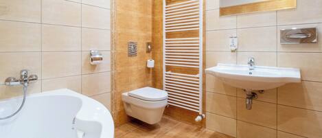 Un baño moderno con bañera, inodoro y lavamanos.