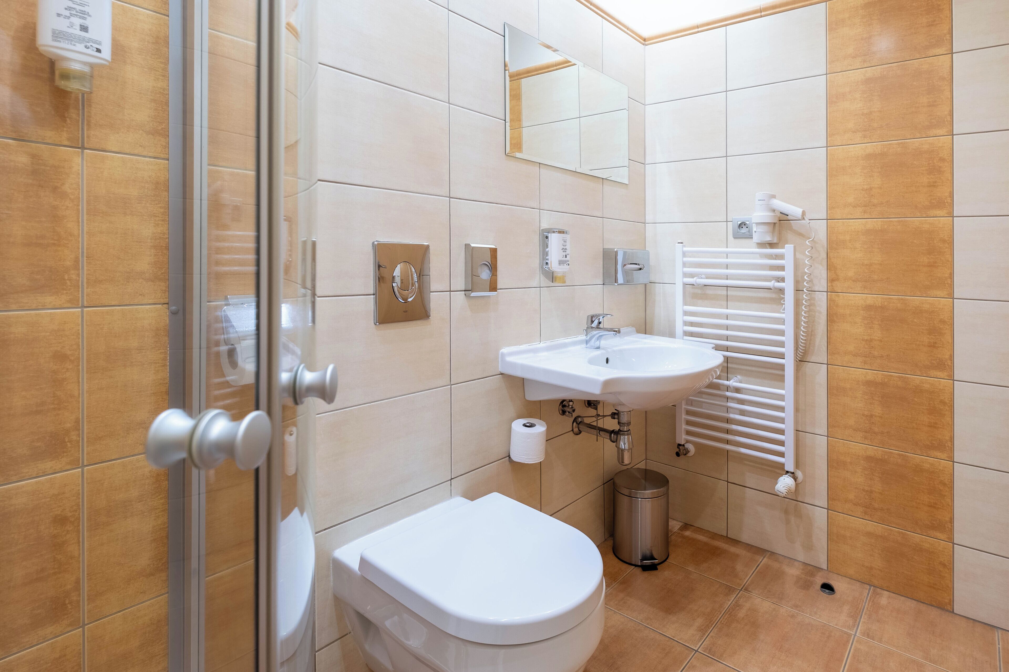 A modern bathroom with a toilet, sink, and shower.