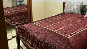 A bedroom with two beds, a wardrobe, and a mirror. - Apartment sidi rahhal near beach (Sidi Rahal)