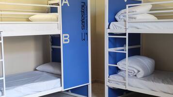 Bunk beds with a blue divider labeled 'A' and 'B' in a room with tiled flooring.