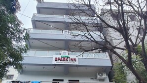 A hotel named "Hotel Spark Inn" with a modern design, featuring a multi-story structure and a gated entrance with decorative panels. - Spark Inn Hotel (Pune)