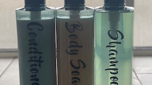 Three bottles of liquid on a tiled surface.