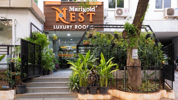 A building with a sign for Marigold Nest Luxury Rooftop. - Hotel Marigold Atnest Gachibowli (Hyderabad)