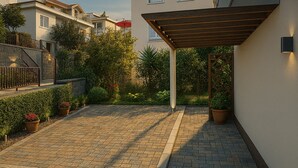 A paved courtyard with a pergola, potted plants, and a stone wall. - 🛏 Apartment 1 - Anna-Nikola, Central Igalo, 5-Min to Beach (Igalo)