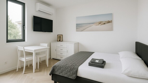 A bedroom with a bed, a desk, a chair, a wardrobe, and a TV. - 🛏 Apartment 1 - Anna-Nikola, Central Igalo, 5-Min to Beach (Igalo)