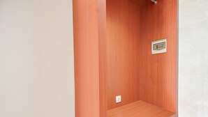 A room with a wooden wall, a small shelf, and a light switch. - Collection O Bali Sanur near Bali Mandara Hospital (Denpasar)