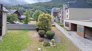 Una zona residencial con casas modernas, un césped bien cuidado y montañas al fondo.