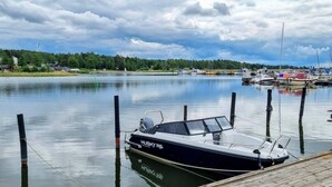 A calm lake with boats docked at a wooden pier.