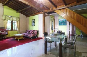 A spacious living area with a high ceiling, a glass dining table, and a red carpet. - Belvilla Bogor near Citra Alam Riverside formerly Jatimas Hijau (Cisarua)