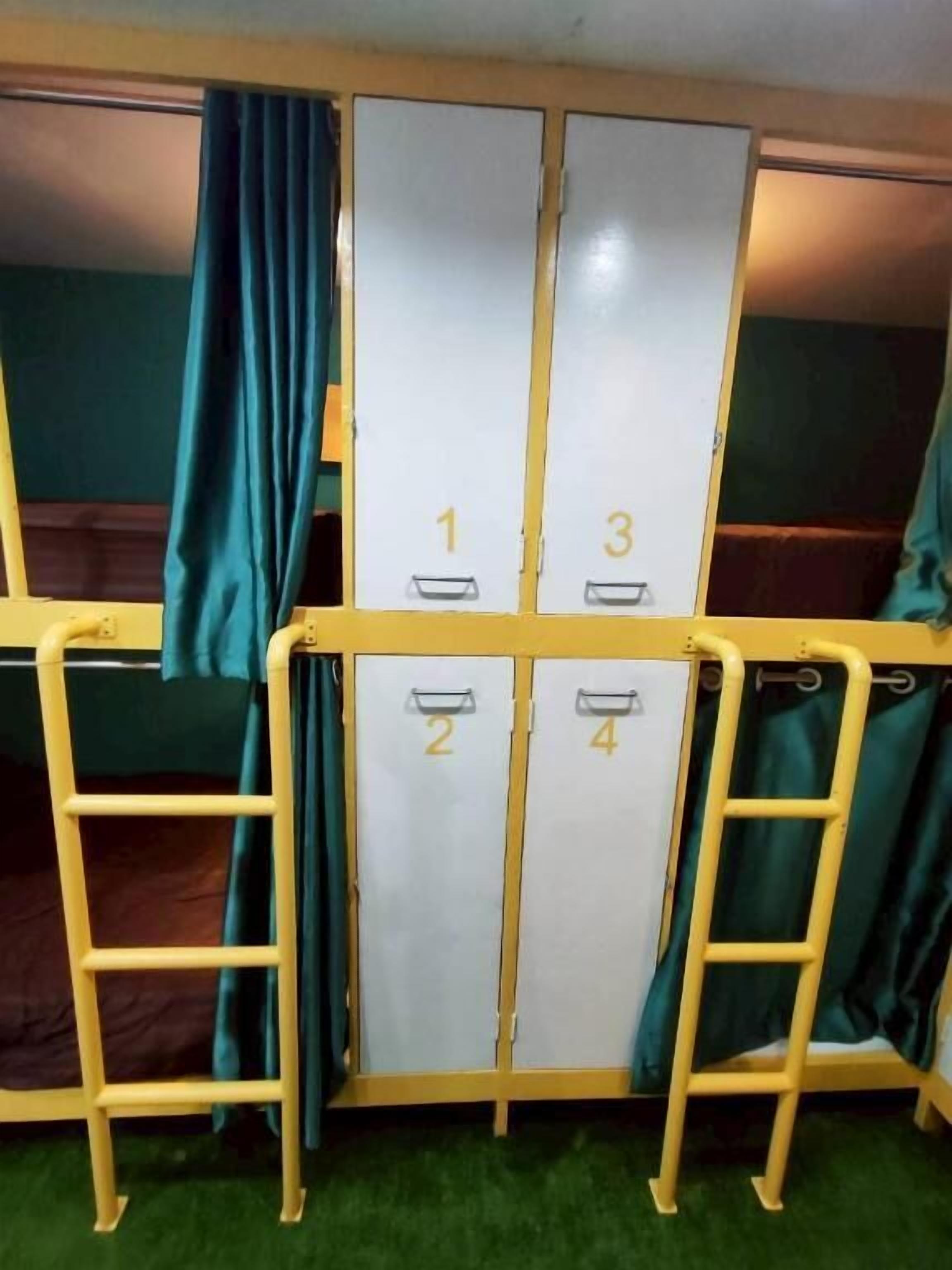 Bunk beds with numbers 1 to 4, a ladder, and curtains.