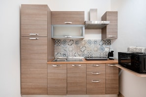 Fridge, microwave, coffee/tea maker, cookware/dishes/utensils