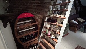 A wine cellar with wooden shelves, a wine rack, and various wine bottles.