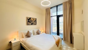 A hotel room with a large bed, a nightstand with a lamp, a window with curtains, and a city view. - Palette Lavish Apartments At Concord Tower With Rooftop Pool (Dubai)