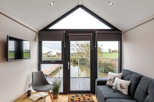 Standard Apartment, Balcony, Lake View | Living area | Flat-screen TV