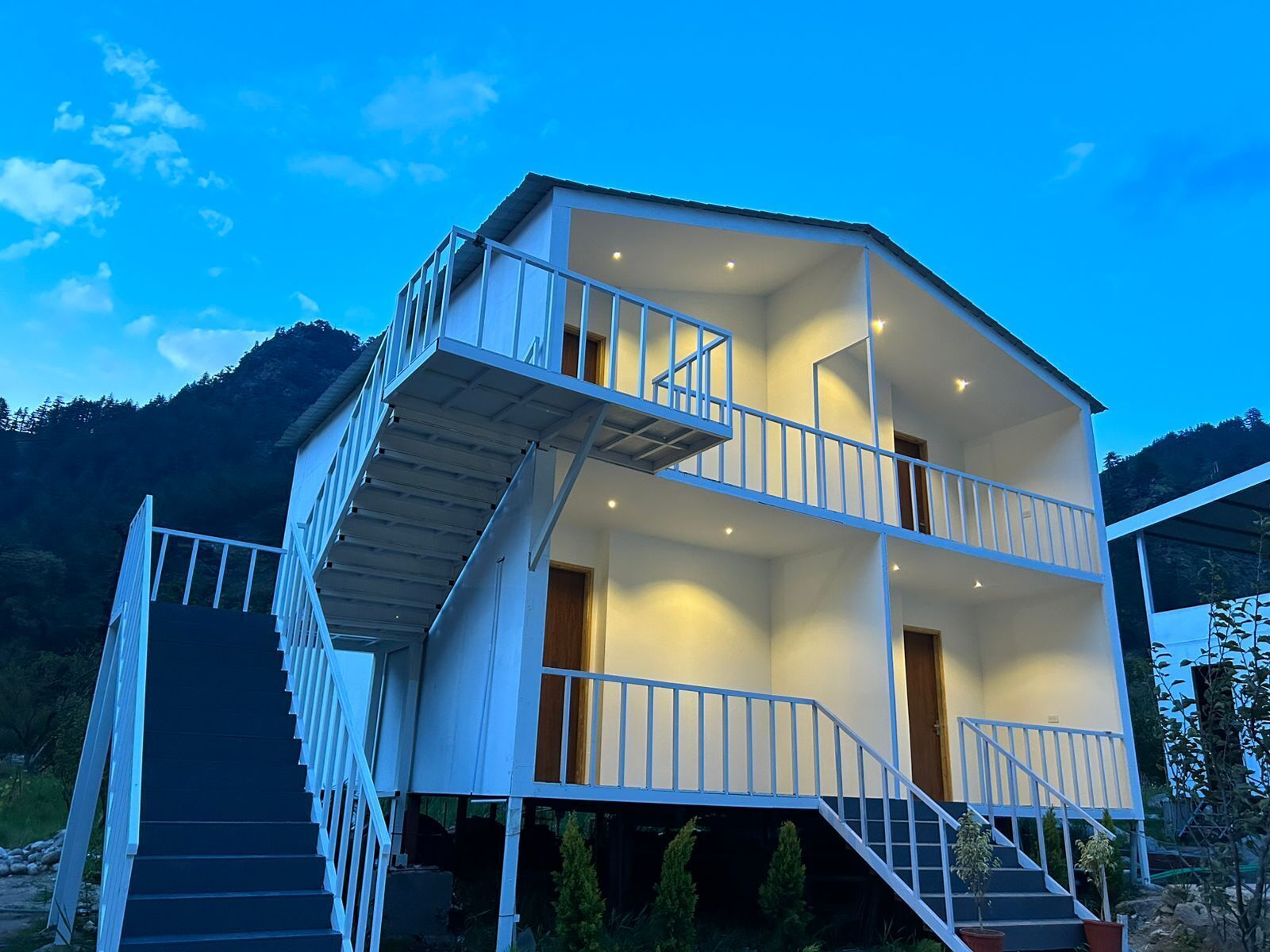 A two-story building with a balcony and a staircase.