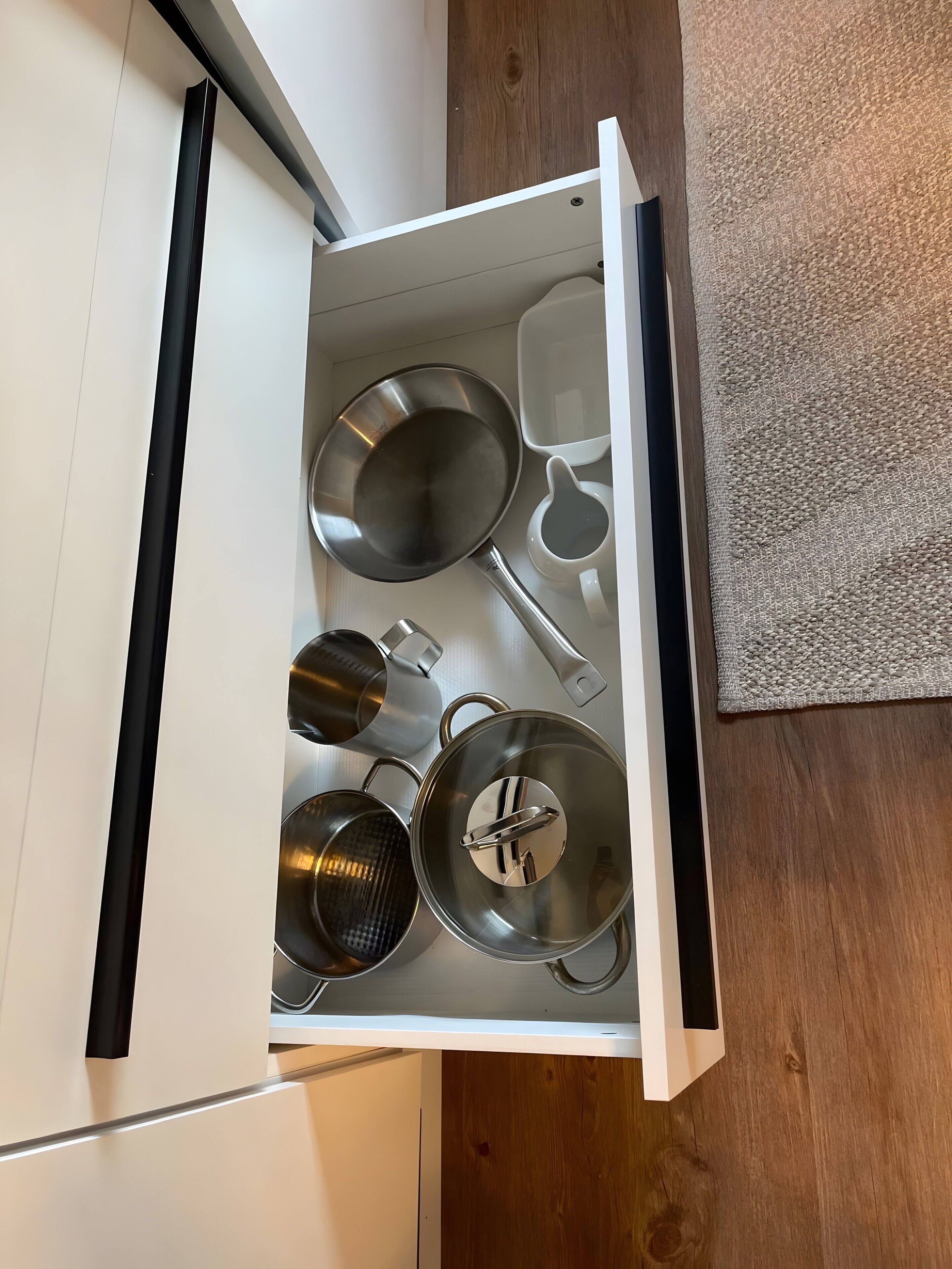 A kitchen drawer with various cookware items.