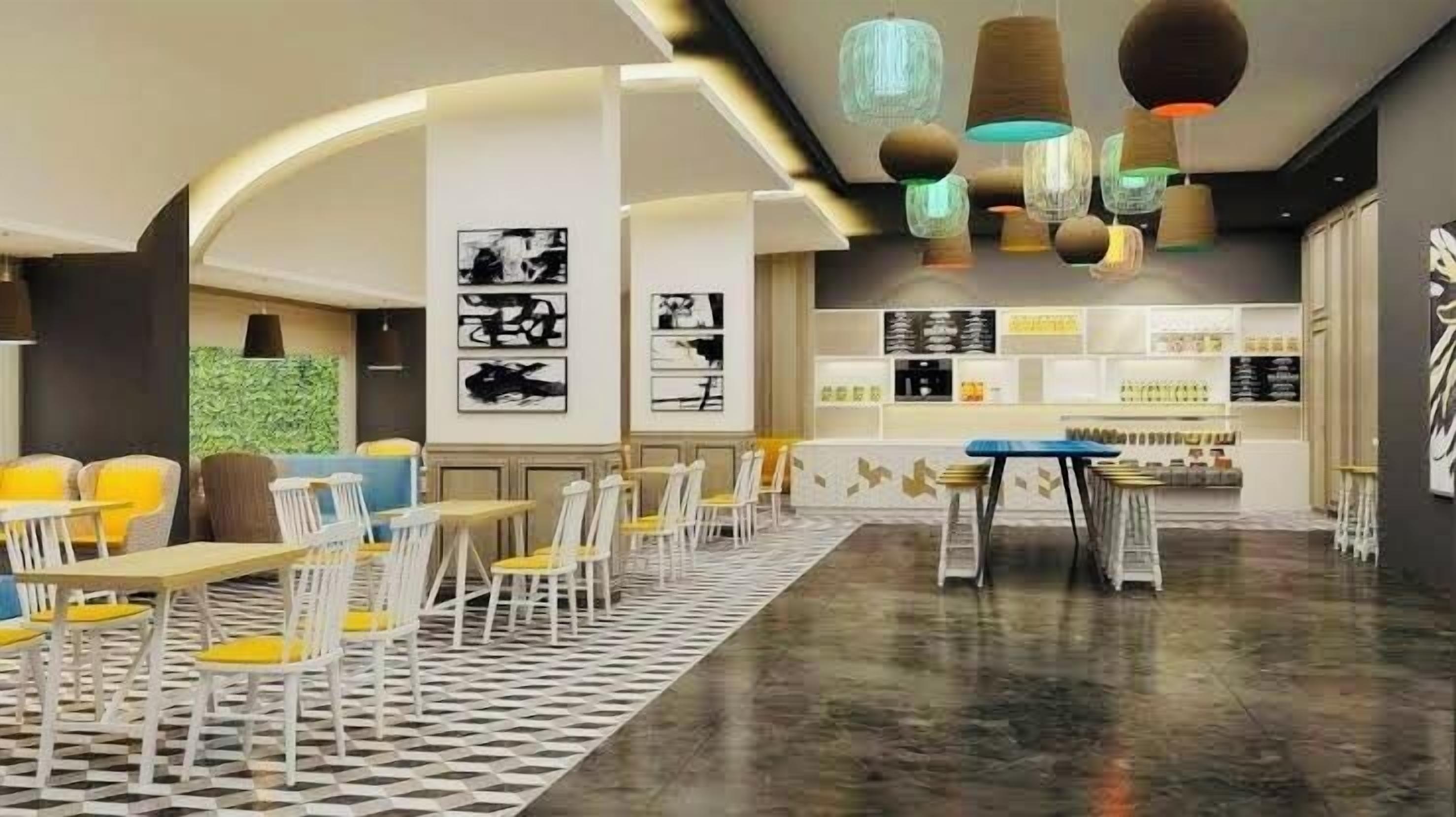 Um café moderno com chão quadriculado, cadeiras brancas e uma mesa central.