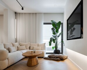 Deluxe Apartment | Living room | 65-inch Smart TV with digital channels