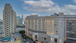 A hotel with a prominent sign, multiple floors, and a view of the surrounding cityscape. - Kennah Lasciac | 3BR Near Tahrir Sq., Downtown (Cairo)