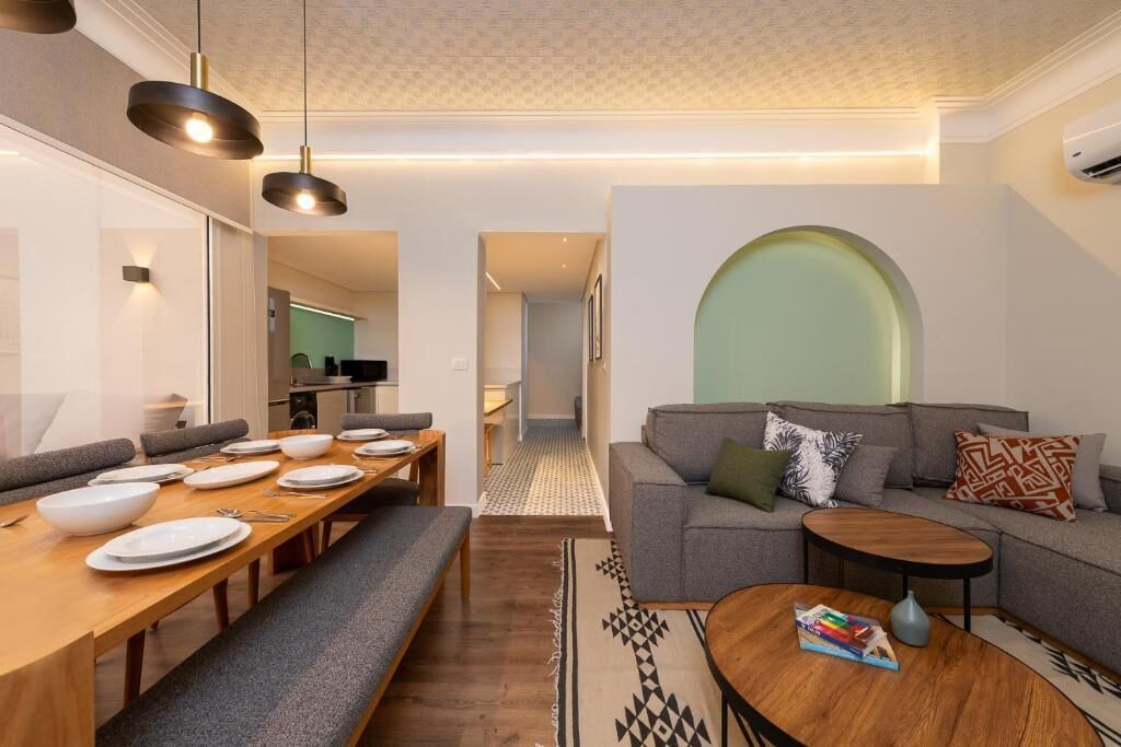 A modern living room with a dining area, a sofa set, and a coffee table.