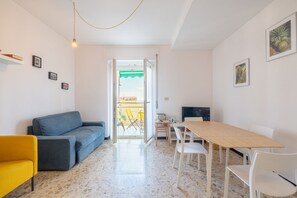 Apartment, Balcony, Sea View | Living area | 30-inch TV with satellite channels