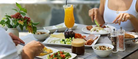 A dining table with various dishes, a beverage, and condiments.