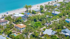 An aerial view of a coastal residential area with houses, a beach, and palm trees. - Ventura Captiva 2b 3 Bedroom Condo (Captiva)