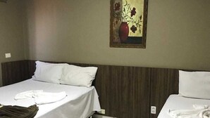 A hotel room with two beds, a painting on the wall, and a tiled floor. - HOTEL NOVA AMERICA (Tres Lagoas)