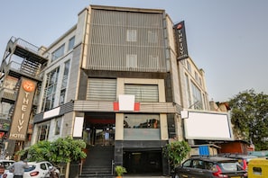 A hotel with a modern facade, multiple windows, and a prominent sign. - The IVY Grand Hotel in City Centre Delhi (New Delhi)