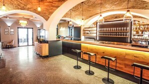 A bar area with wooden accents, a counter, and a wine display. - Hotel Mariel Znojmo (Znojmo)