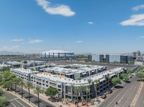 A modern urban area with a large stadium and multi-story buildings.