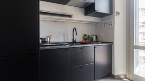 A modern kitchen with a built-in stove, sink, and cabinets. - Italianway Easy - Giambellino 67 A (Milano)