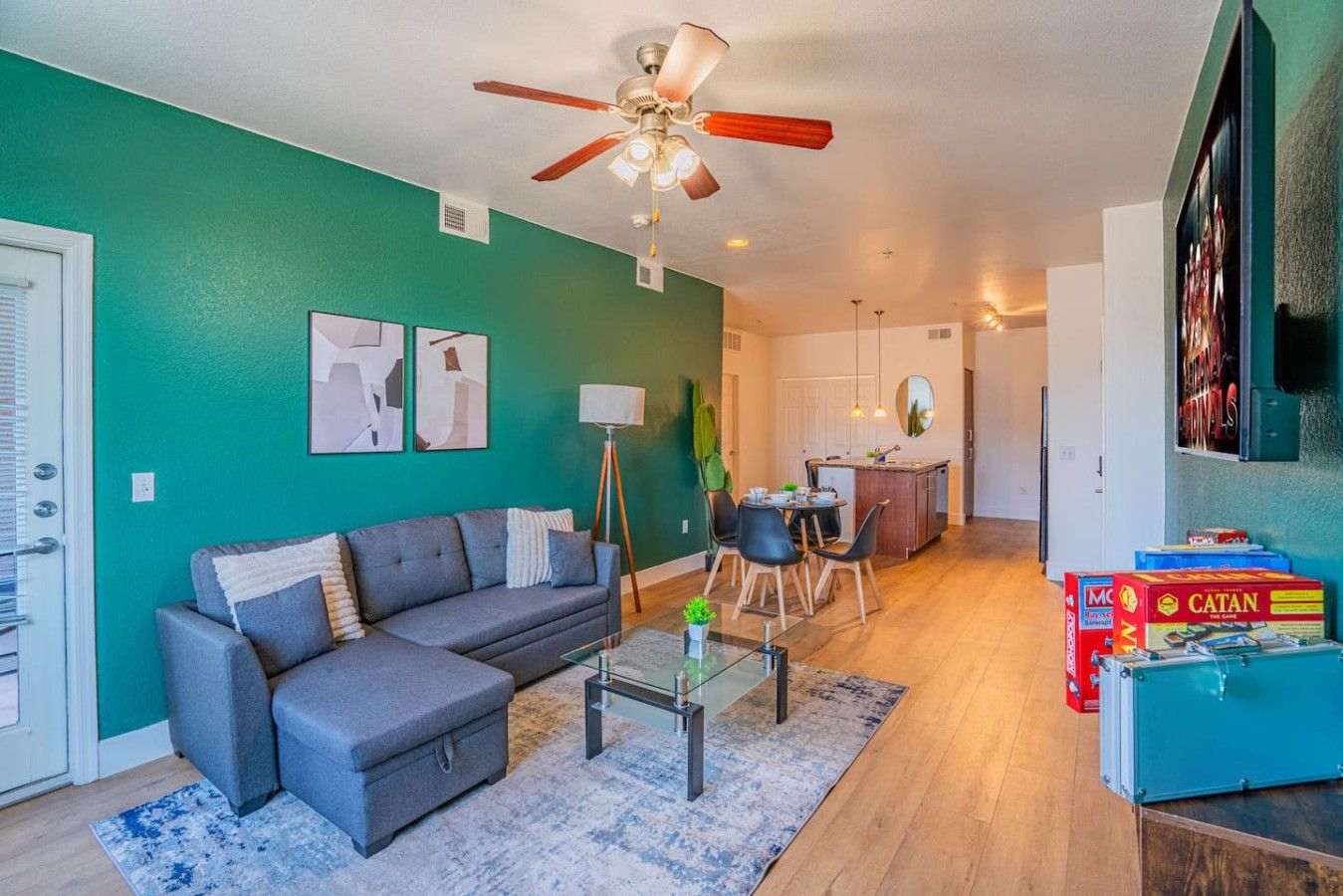 A living room with a sofa, coffee table, and a ceiling fan.