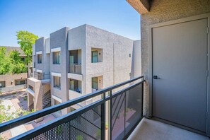 Un immeuble à plusieurs étages doté de balcons, d’une entrée sécurisée et d’une cour intérieure.