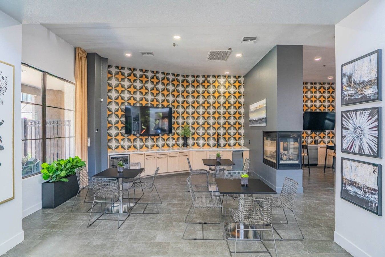A modern interior with a kitchen area, dining space, and a living area with a TV.