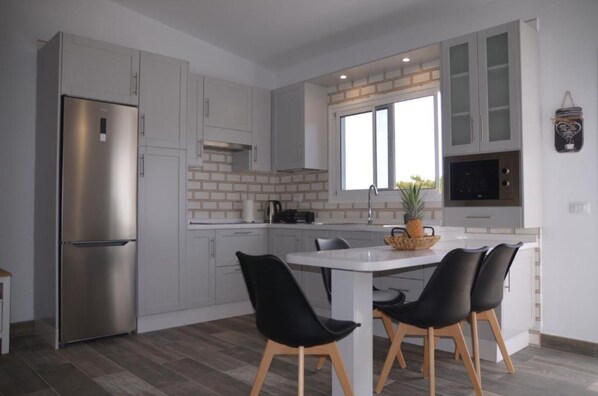 Fridge, microwave, stovetop, coffee/tea maker