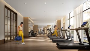 A modern gym with treadmills, exercise bikes, and weights. - voco Wugong Mountain Jiangxi by IHG (Pingxiang)