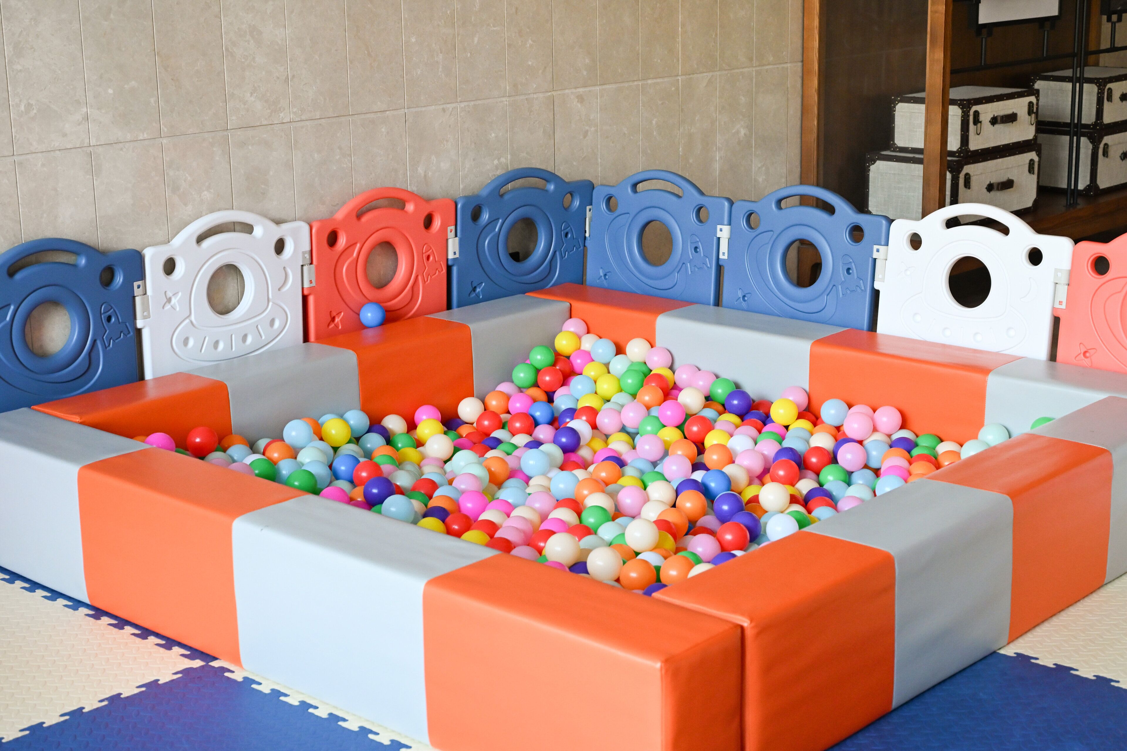 A play area with a ball pit and padded play structures.