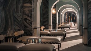 A hotel lobby with marble walls, arched ceilings, and a central seating area with sofas and tables. - Hotel Indigo Wuxi Qingming Bridge by IHG (Wuxi)