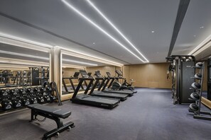 A gym with treadmills, dumbbells, and weight machines. - Hotel Indigo Wuxi Qingming Bridge by IHG (Wuxi)
