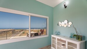 A room with a large window, a white cabinet, and a view of the outdoors. - Holiday Home 'Elvira' with Sea View, Private Terrace and Wi-Fi (La Frontera)