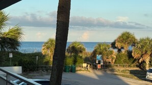 A coastal road with palm trees and a view of the ocean. - Unit # 321 (Cocoa Beach)